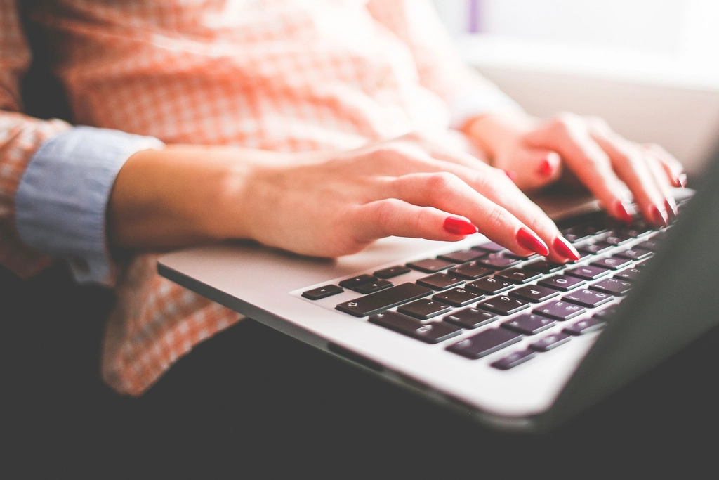 Person working on a laptop at a desk